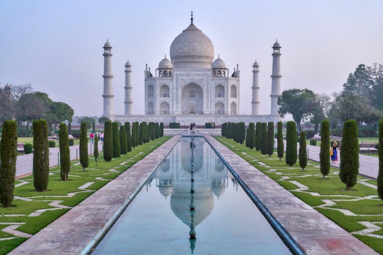 The Taj Mahal in Agra reflected in its long water channel at sunrise